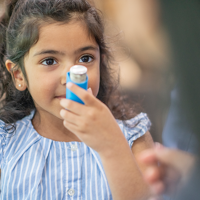 child using an inhaler 