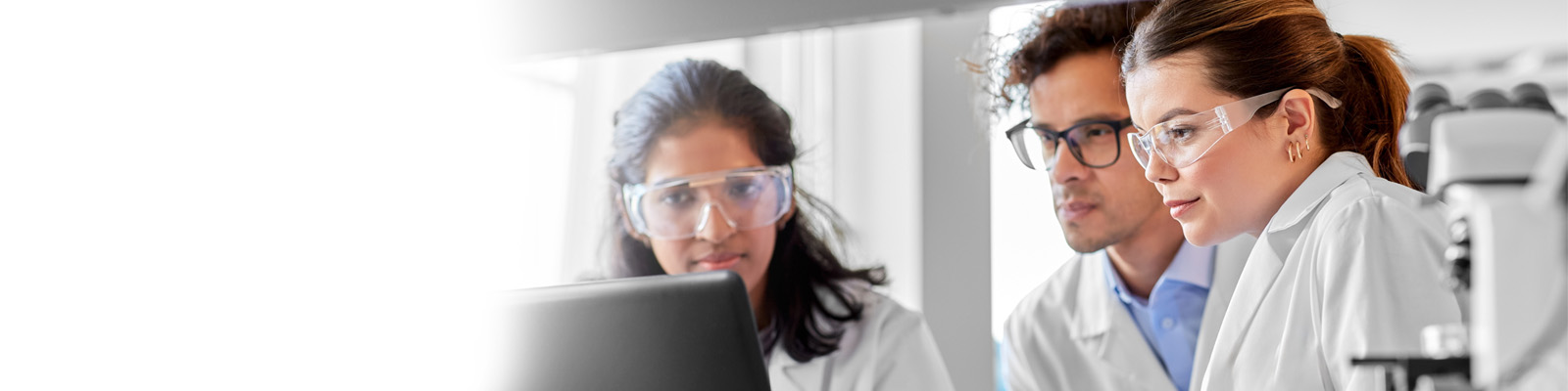 Scientists looking at a computer in a lab