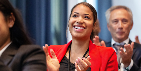 woman in audience smiling