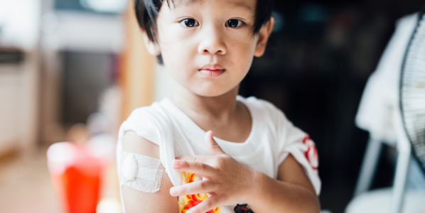 child with bandaid on arm